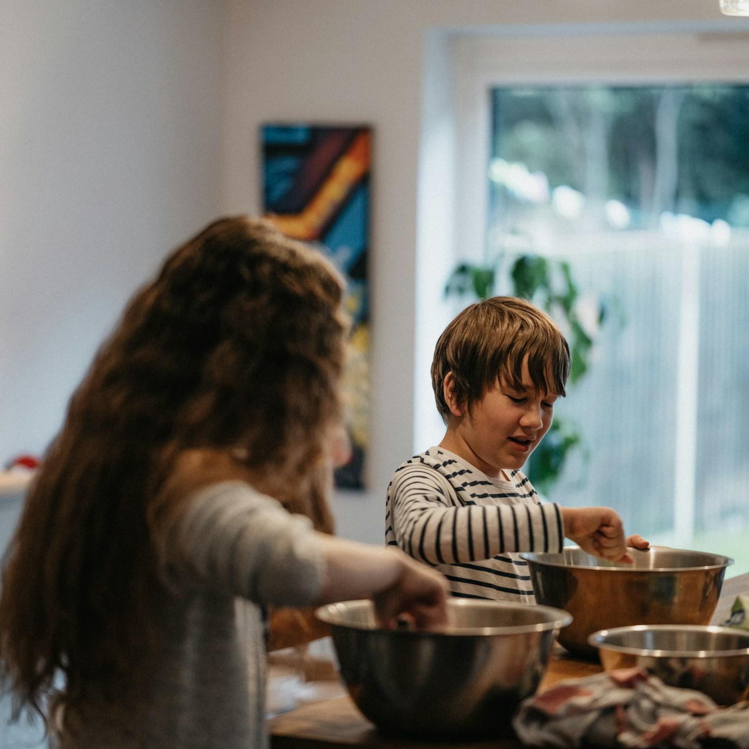 Diverse group of community members sharing a meal together, showcasing the social bonds formed through collaborative cooking